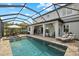 Exterior view of home with screened patio, pool, outdoor seating and lake view at 2818 Starwood Ct, Lakewood Ranch, FL 34211