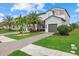 Lovely home featuring a stone facade, three car garage, and lush green landscaping at 2818 Starwood Ct, Lakewood Ranch, FL 34211