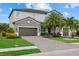 Two-story home with three-car garage, stone facade, and well-maintained landscaping at 2818 Starwood Ct, Lakewood Ranch, FL 34211