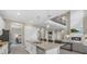 Open concept kitchen showcasing an island with seating, stainless steel appliances, and seamless flow to the living space at 2818 Starwood Ct, Lakewood Ranch, FL 34211