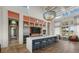 Modern kitchenette with stainless steel appliances, a breakfast bar, and plenty of storage space at 2818 Starwood Ct, Lakewood Ranch, FL 34211