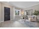 Bright living room with tiled floors, a statement door, and contemporary furniture, creating an inviting and stylish space at 2818 Starwood Ct, Lakewood Ranch, FL 34211