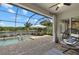 Covered patio with a screened enclosure, features a pool, spa, lake view, and lounge area at 2818 Starwood Ct, Lakewood Ranch, FL 34211