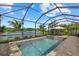 Screened pool with a built-in spa surrounded by brick pavers with a beautiful lake view at 2818 Starwood Ct, Lakewood Ranch, FL 34211