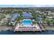 Aerial view of a resort-style pool surrounded by palm trees and community amenities at 2818 Starwood Ct, Lakewood Ranch, FL 34211