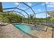 Beautiful screened pool and spa with brick pavers, lounge chairs and lake view at 2818 Starwood Ct, Lakewood Ranch, FL 34211