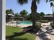 Resort-style community pool surrounded by palm trees and lounge chairs for relaxing at 3018 Oriole Dr, Sarasota, FL 34243