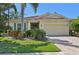 Charming one-story home with a clay tile roof, two-car garage, and well-maintained landscaping at 3018 Oriole Dr, Sarasota, FL 34243