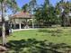 Community gazebo with a picnic table set in a lush, green lawn at 3018 Oriole Dr, Sarasota, FL 34243