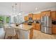 Spacious kitchen with stainless steel appliances, a large center island, and seamless access to the living area at 3018 Oriole Dr, Sarasota, FL 34243