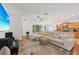 Comfortable living room featuring a large sectional sofa, wooden floors, and views of the backyard at 3018 Oriole Dr, Sarasota, FL 34243