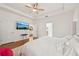 Bright main bedroom with hardwood floors, a ceiling fan, and TV at 3018 Oriole Dr, Sarasota, FL 34243