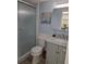 Bathroom featuring a modern vanity, elegant lighting fixtures, and a glass-enclosed shower at 3368 Lake Bayshore Dr # 217 Building P, Bradenton, FL 34205