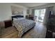 Comfortable bedroom with a queen-size bed, wooden furnishings, and a balcony overlooking the water at 3368 Lake Bayshore Dr # 217 Building P, Bradenton, FL 34205