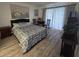 Bedroom with a comfortable bed, wooden furniture, and sliding doors leading to the balcony at 3368 Lake Bayshore Dr # 217 Building P, Bradenton, FL 34205