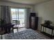 Bedroom featuring water view from a sliding door, wood-look flooring, and a chest of drawers at 3368 Lake Bayshore Dr # 217 Building P, Bradenton, FL 34205