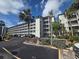 Exterior view of a condo complex showing multiple balconies, palm trees and well-maintained landscaping at 3368 Lake Bayshore Dr # 217 Building P, Bradenton, FL 34205