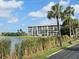 Scenic exterior shot of a lakefront property with multi-story buildings and lush landscaping at 3368 Lake Bayshore Dr # 217 Building P, Bradenton, FL 34205