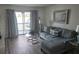 Cozy living room with plush sofa, glass coffee table, and view of the outdoor balcony with seating at 3368 Lake Bayshore Dr # 217 Building P, Bradenton, FL 34205