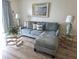 Comfortable living room with a stylish sectional couch, glass tables, and elegant decor at 3368 Lake Bayshore Dr # 217 Building P, Bradenton, FL 34205