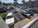 Overhead shot of a well-maintained parking lot surrounded by palm trees and multi-story buildings at 3368 Lake Bayshore Dr # 217 Building P, Bradenton, FL 34205