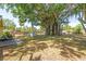 Large backyard featuring mature trees, a deck, and plenty of space for outdoor enjoyment at 337 Somerset Ave, Sarasota, FL 34243
