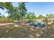 Large fenced backyard featuring lush trees and outdoor seating area at 337 Somerset Ave, Sarasota, FL 34243