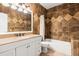 Bathroom showcasing designer tile, tub, vanity with granite countertop, and stylish mirror at 337 Somerset Ave, Sarasota, FL 34243