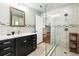 Modern bathroom with a glass enclosed shower, dark vanity and white countertop at 337 Somerset Ave, Sarasota, FL 34243