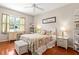 Bright bedroom featuring hardwood floors, cheerful floral bedding and wicker furniture at 337 Somerset Ave, Sarasota, FL 34243