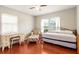 Bedroom with hardwood floors, a desk and a bed with a trundle and floral chair at 337 Somerset Ave, Sarasota, FL 34243