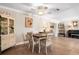 Cozy dining area with tile floors, a ceiling fan and an antique hutch at 337 Somerset Ave, Sarasota, FL 34243