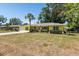 Home's bright exterior with green grass, a driveway, and well-maintained landscaping at 337 Somerset Ave, Sarasota, FL 34243
