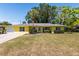 Charming yellow single-story home featuring a well-manicured lawn and a mature palm tree in the front yard at 337 Somerset Ave, Sarasota, FL 34243