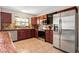 Kitchen area with stainless appliances, granite counters, and cherry cabinets at 337 Somerset Ave, Sarasota, FL 34243