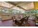 Enclosed sun room with multiple seating options and an outdoor view at 337 Somerset Ave, Sarasota, FL 34243