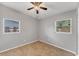 Neutral bedroom featuring tile flooring, a ceiling fan, and natural light at 3545 Lalani Blvd, Sarasota, FL 34232