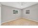 Cozy bedroom featuring tile flooring, neutral walls, and bright windows at 3545 Lalani Blvd, Sarasota, FL 34232