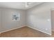 Bedroom featuring tile flooring, neutral walls, and a bright window at 3545 Lalani Blvd, Sarasota, FL 34232