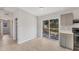 Open concept dining area featuring tile floors, sliding door access to the backyard, and kitchen access at 3545 Lalani Blvd, Sarasota, FL 34232