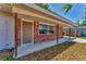 Inviting entrance featuring a brick facade, covered porch, and a well-maintained walkway at 3545 Lalani Blvd, Sarasota, FL 34232