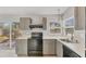 Well-appointed kitchen with black appliances, gray cabinetry, and bright natural light at 3545 Lalani Blvd, Sarasota, FL 34232