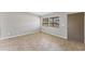 Bright, neutrally decorated living room featuring tile floors and a large window at 3545 Lalani Blvd, Sarasota, FL 34232