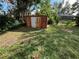 Storage shed with double doors in a grassy backyard at 3612 27Th W Ave, Bradenton, FL 34205