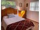 Inviting bedroom with cozy bed, wooden furniture, and natural light streaming through the large window at 3612 27Th W Ave, Bradenton, FL 34205
