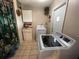 Well-equipped laundry room with modern washer and dryer, ample storage, and convenient outdoor access at 3612 27Th W Ave, Bradenton, FL 34205