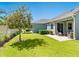 Lush backyard with manicured lawn, patio, privacy fence, and landscaping at 3623 Pitch Ln, Sarasota, FL 34232