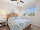 Bright bedroom with two windows, beach-themed decor, and wicker headboard at 3623 Pitch Ln, Sarasota, FL 34232