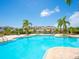 Beautiful community pool surrounded by palm trees and well-maintained landscaping at 3623 Pitch Ln, Sarasota, FL 34232