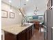 An open kitchen with stainless appliances and a large island adjacent to a dining and living area at 3623 Pitch Ln, Sarasota, FL 34232